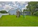 Spacious backyard with lush lawn, playground, and screened-in pool, perfect for Gathering fun at 3633 Springville Dr, Valrico, FL 33596