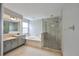 Bright bathroom featuring dual sinks, soaking tub and large walk-in shower with glass door at 3633 Springville Dr, Valrico, FL 33596