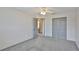 This cozy bedroom features plush carpeting, a ceiling fan, closet, and adjacent bathroom access at 3633 Springville Dr, Valrico, FL 33596