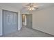This cozy bedroom features plush carpeting, a ceiling fan, and a closet for ample storage space at 3633 Springville Dr, Valrico, FL 33596