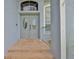 Elegant double doors with decorative windows, complemented by brick steps and a welcoming entryway at 3633 Springville Dr, Valrico, FL 33596