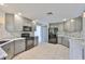 Bright kitchen with grey cabinets, modern appliances, and tile floors for easy maintenance at 3633 Springville Dr, Valrico, FL 33596
