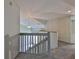 Carpeted landing with views of the living room below at 3633 Springville Dr, Valrico, FL 33596