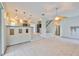 Spacious living room open to kitchen featuring tile floors and access to the backyard at 3633 Springville Dr, Valrico, FL 33596