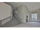 Elegant staircase with gray carpet leading to upper level, complemented by neutral tile flooring at 3633 Springville Dr, Valrico, FL 33596