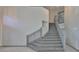 A carpeted staircase featuring gray railings leading to the upper level of the house at 3633 Springville Dr, Valrico, FL 33596