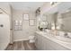 Bright bathroom with double sink vanity, shower with neutral curtain, and modern fixtures at 37106 Sagemoor Dr, Zephyrhills, FL 33541