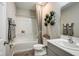 Well-lit bathroom featuring a shower-tub combo, decorative wall plants, and a modern-style vanity with sink at 37106 Sagemoor Dr, Zephyrhills, FL 33541