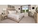 Comfortable bedroom featuring a plush bed, side tables, and a sitting area bathed in natural light at 37106 Sagemoor Dr, Zephyrhills, FL 33541