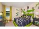 bedroom featuring dinosaur decorations, green bed set, and a scenic view out of the window at 37106 Sagemoor Dr, Zephyrhills, FL 33541