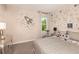 bedroom featuring rocket and star decorations with a gray and white bed set and side table at 37106 Sagemoor Dr, Zephyrhills, FL 33541