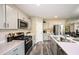 Contemporary kitchen boasts gray cabinets, stainless appliances, and quartz countertops at 37106 Sagemoor Dr, Zephyrhills, FL 33541