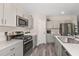 This kitchen features stainless appliances, gray cabinets and plenty of counter space at 37106 Sagemoor Dr, Zephyrhills, FL 33541