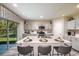 Open eat-in kitchen with breakfast bar seating, stainless steel appliances and sliding glass door at 37106 Sagemoor Dr, Zephyrhills, FL 33541