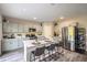 Bright eat-in kitchen featuring a large island with seating and stainless steel appliances at 37106 Sagemoor Dr, Zephyrhills, FL 33541