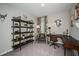 Bright office featuring a dark wood desk, shelving, and chair, plus decorative curtains and neutral walls at 37106 Sagemoor Dr, Zephyrhills, FL 33541