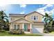 Charming two-story home with well-manicured lawn, stone accents, and a vibrant turquoise front door at 3712 Rocky Island Rd, New Port Richey, FL 34655