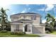 Charming two-story home with a neutral palette, covered porch, black trim windows, and well-kept lawn and landscaping at 3736 Rocky Island Rd, New Port Richey, FL 34655