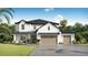 Charming two-story home featuring a 3-car garage, lush landscaping, and a welcoming facade at 3912 W San Rafael St, Tampa, FL 33629