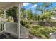 View of the fenced backyard with lush greenery from the shaded back porch at 3953 10Th S Ave, St Petersburg, FL 33711