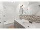Bathroom featuring double sinks, mosaic tile accents, and a shower-tub combo at 3953 10Th S Ave, St Petersburg, FL 33711