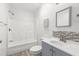 Cozy bathroom features a shower-tub combo, stylish vanity, and decorative mosaic tile detail at 3953 10Th S Ave, St Petersburg, FL 33711
