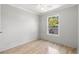 Bright bedroom featuring hardwood floors, a ceiling fan, and a window with a view of the yard at 3953 10Th S Ave, St Petersburg, FL 33711
