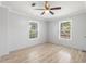 Bright bedroom featuring two windows and a ceiling fan at 3953 10Th S Ave, St Petersburg, FL 33711