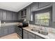Updated kitchen with stainless steel appliances and gray cabinetry at 3953 10Th S Ave, St Petersburg, FL 33711