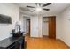 Well-lit bedroom with ceiling fan, desk space, and closet at 4318 Mesa Dr, New Port Richey, FL 34653