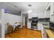 Well-lit kitchen featuring stainless steel appliances, sleek countertops, and stylish hardwood flooring at 4318 Mesa Dr, New Port Richey, FL 34653