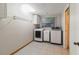 Functional laundry room featuring washer, dryer, cabinetry, and window providing natural light at 4318 Mesa Dr, New Port Richey, FL 34653