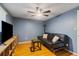 Comfortable living room features ceiling fan, TV, couch, and bright window light at 4318 Mesa Dr, New Port Richey, FL 34653