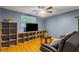 Comfortable living room features built-in shelving, TV, and chair with bright window light at 4318 Mesa Dr, New Port Richey, FL 34653