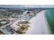 Breathtaking aerial view showcasing the condo complex, sandy beach and waterfront community at 4450 Gulf Blvd # 110, St Pete Beach, FL 33706
