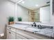 This bathroom features a granite vanity with a generous mirror and a shower with a glass enclosure at 4450 Gulf Blvd # 110, St Pete Beach, FL 33706