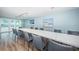 Elegant dining area featuring a long table with seating and sliding glass doors leading to an outdoor patio at 4450 Gulf Blvd # 110, St Pete Beach, FL 33706