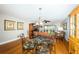 Bright dining area with glass table, seating for four, and sliding door to the balcony at 4450 Gulf Blvd # 110, St Pete Beach, FL 33706