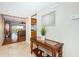 Inviting entryway featuring tile floors, a decorative table, and an open view to the living room at 4450 Gulf Blvd # 110, St Pete Beach, FL 33706