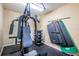 Well-equipped home gym with weight machines, free weights, and exercise mats for a complete workout experience at 4450 Gulf Blvd # 110, St Pete Beach, FL 33706