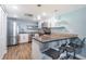 Contemporary kitchen with stainless steel appliances, white cabinets, a breakfast bar, and modern pendant lighting at 4450 Gulf Blvd # 110, St Pete Beach, FL 33706