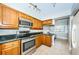 Modern kitchen features stainless steel appliances, wood cabinets and tiled floors at 4450 Gulf Blvd # 110, St Pete Beach, FL 33706