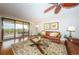 Comfortable living room features a large leather couch, ocean view balcony, and stylish decor at 4450 Gulf Blvd # 110, St Pete Beach, FL 33706