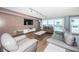 Bright living room with stylish furnishings, a large television, and sliding glass doors to the outdoor deck area at 4450 Gulf Blvd # 110, St Pete Beach, FL 33706