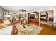 Comfortable living room featuring a large leather couch, stylish fan, and access to the primary bedroom at 4450 Gulf Blvd # 110, St Pete Beach, FL 33706