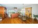 Open living space features a dining area and living room with ocean views from the sliding glass door at 4450 Gulf Blvd # 110, St Pete Beach, FL 33706