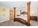 Spacious main bedroom featuring a four-poster bed and an ensuite bath at 4450 Gulf Blvd # 110, St Pete Beach, FL 33706
