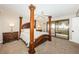 Spacious main bedroom featuring a four-poster bed and sliding doors leading to an ocean-view balcony at 4450 Gulf Blvd # 110, St Pete Beach, FL 33706