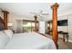 This main bedroom boasts a four poster bed, ceiling fan, and access to a balcony at 4450 Gulf Blvd # 110, St Pete Beach, FL 33706