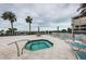 Inviting rooftop deck featuring a hot tub, lounge chairs, and ocean views for ultimate relaxation and entertainment at 4450 Gulf Blvd # 110, St Pete Beach, FL 33706